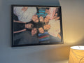 Family photo of our 7 children stitched in 18ct. A family moment in stitches: children in a circle, heads together, dark background