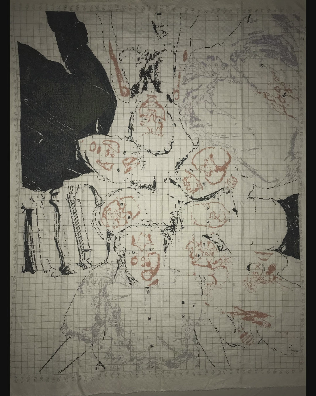 Family photo of our 7 children stitched in 18ct. A family moment in stitches: children in a circle, heads together, dark background