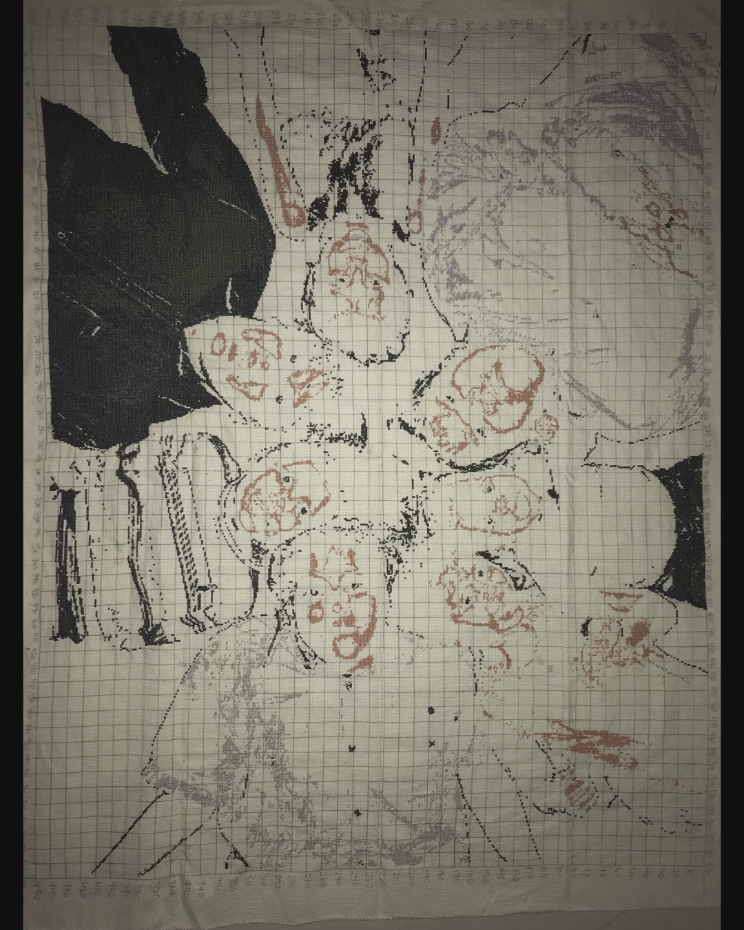 Family photo of our 7 children stitched in 18ct. A family moment in stitches: children in a circle, heads together, dark background